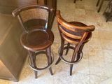 two wooden stools sitting next to each other on a tiled floor