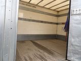 a truck with a door open in a storage area