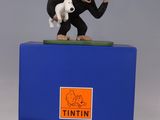 a figurine of a monkey and a dog on top of a blue box