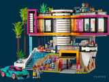 a toy house with a car in front of it and a car in front of it
