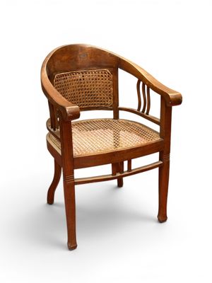 an image of a wooden chair with a wicker seat on a white background