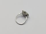a close up of a silver ring with a stone on it