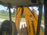 a back end of a tractor that is parked on the side of the road
