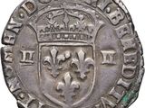 a close up of a silver coin with a crown on it