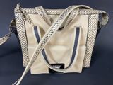 an image of a white and black purse on a blue background
