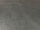 a close up of a black leather surface with a white background