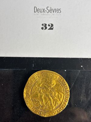 a close up of a gold coin on display in a glass case