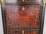 an antique wooden chest of drawers with gold trimming on the drawers