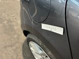 a close up of a car door with a sticker on it