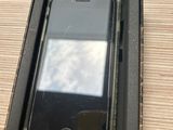 an iphone in a black box on a wooden table