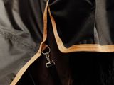 a close up of a horse ' s coat with a keychain on it