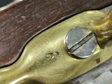 a close up of a metal object on a wooden surface