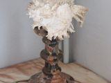 a small vase with a flower on a marble table