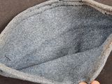 a hand that is holding a piece of fabric
