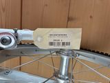a close up of a bicycle wheel with a price tag attached to it