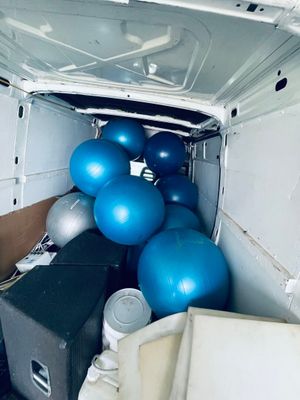 a white van with a bunch of blue balls in the back