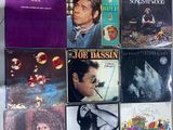many different album covers on the wall of a room
