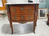 a marble top chest of drawers on display in a room