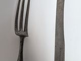 two forks and a knife on a table
