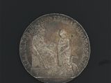 une vieille pièce d'argent sur laquelle figurent un homme et une femme