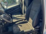 the interior of a white van with black seats and a steering wheel