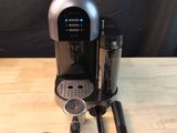 an image of a coffee maker on a wooden table