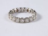 a close up of a diamond ring on a white surface