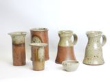 a group of vases that are sitting on a table