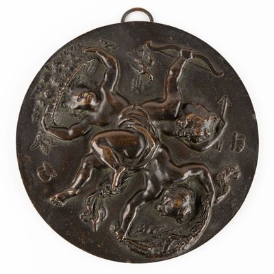 une médaille antique en bronze représentant un homme à cheval et une femme à cheval