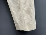 an image of a pair of beige pants hanging on a wall