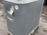 a refrigerator that is sitting in the dirt near a truck