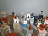 many bottles of perfume sitting on a table