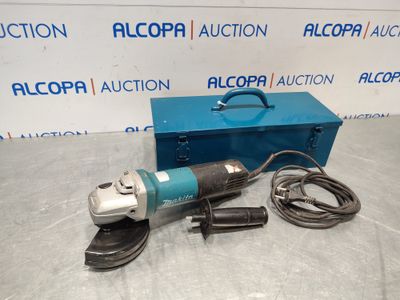 an electric angle grinder with a blue box on a table