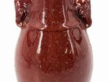 a brown vase with a handle on a white background