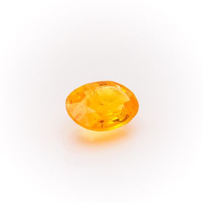 a yellow sapphire stone on a white background