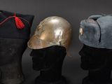 three hats are lined up on top of a mannequin head