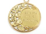 a gold medal with a picture of a woman on it