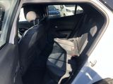 the back seat of a car with the door open in a parking lot