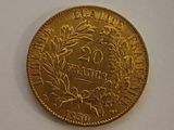 a gold coin on a white surface with a white background