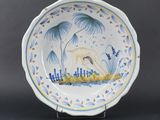 a close up of a plate with a bird on it
