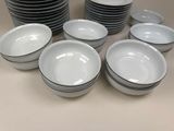 a lot of plates and bowls sitting on a table