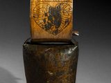 an old wooden box sitting on top of a metal container