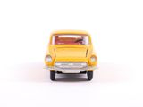 yellow toy car on a white surface with a white background