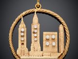 un gros plan sur un pendentif en or représentant une ville