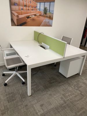 a white desk with a computer on top of it