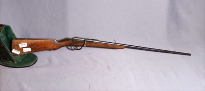 an old rifle with a green case and a wooden handle