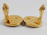 pair of gold plated cufflinks with a man and a woman on them