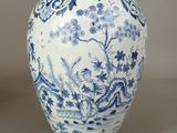 a blue and white vase sitting on a table