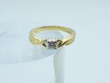 an image of a diamond ring sitting on top of a glass of water