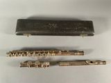 a close up of a flute and a case on a table